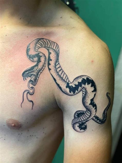 snake tattoo between breast|snake sternum tattoo.